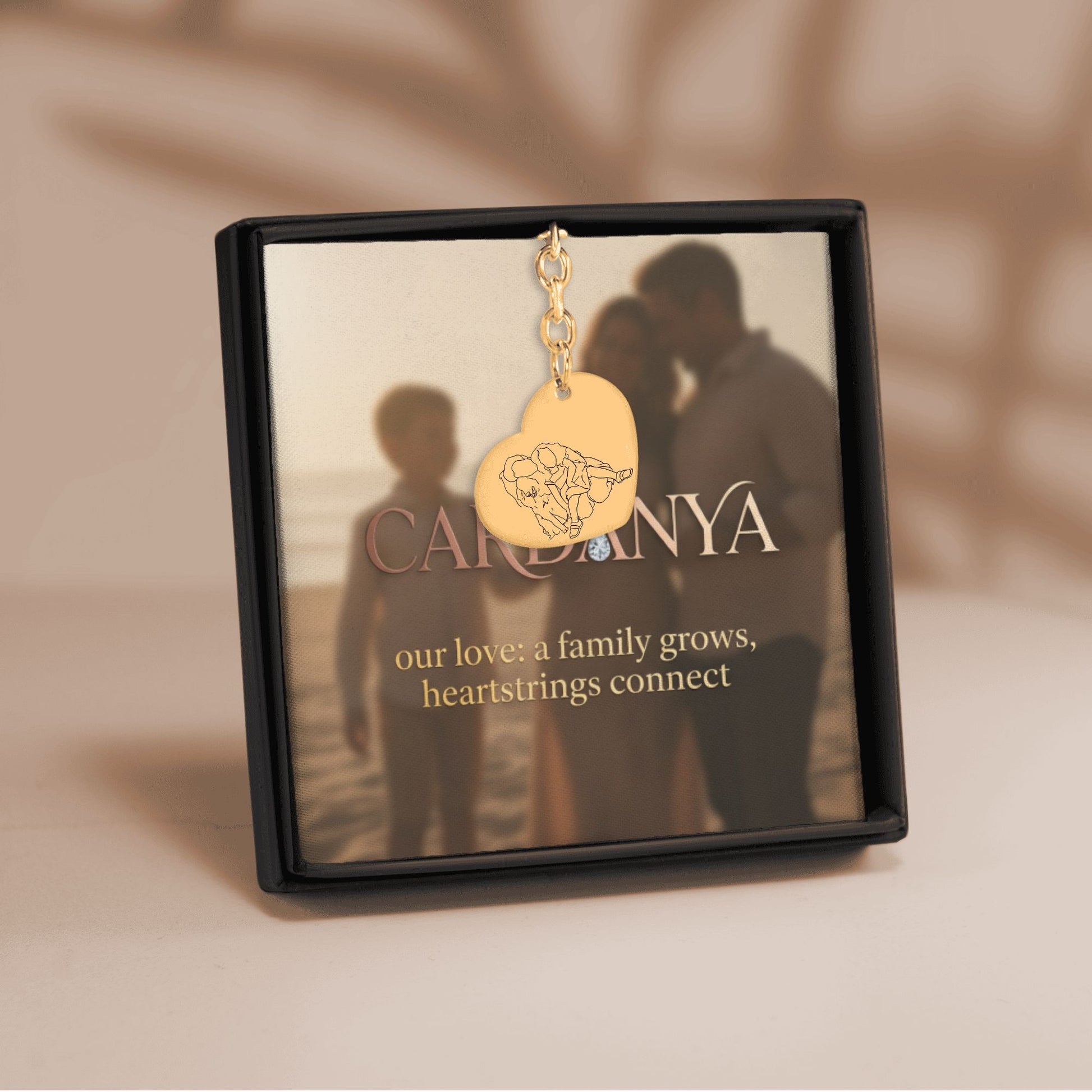 Cardanya 'Eternal Bond' gift box displaying a gold heart pendant with custom family line art engraving and sentimental message card.